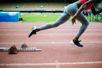 Close-up of young black athlete running in a stadium.