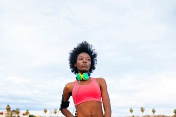 Young black woman resting after exercising outdoors