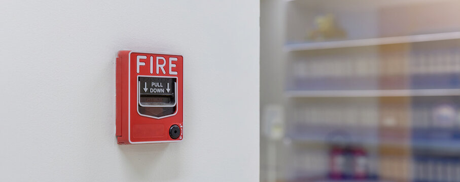 Activate fire alarm trigger system which is installed on granite wall of the building. Fire alarm device that installed on building wall, press the button to activate sound in emergency fire case