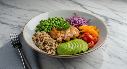 Delight in this vibrant and healthy quinoa bowl, featuring grilled chicken, fresh avocado, and a medley of colorful vegetables, a perfect light meal.