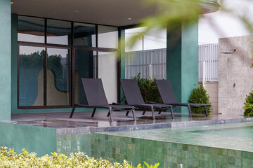 Modern Private Pool Villa with Sun Loungers and Lush Greenery