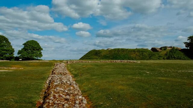 Concentric earthwork banks and weathered masonry remnants capturing the ancient fortifications, Old Sarum, Salisbury, Wiltshire, England, UK