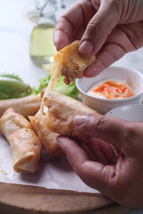 hand holding Fried spring rolls filled with meaty bolognese sauce and mozarella cheese
