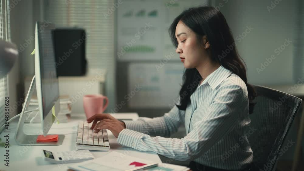 Poster professional businesswoman focusing intently on computer screen, typing rapidly while working late i