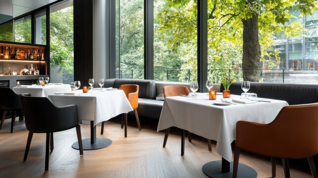 Elegant dining experience in a modern restaurant with large offering a serene view of the lush natural surroundings