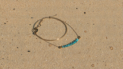 Colorful beach accessories spread across golden sand