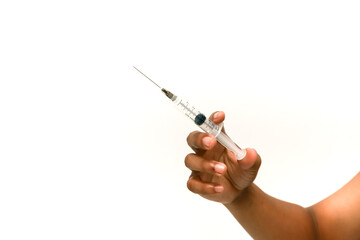 A dark-skinned hand holds a syringe on a white background representing medical treatment and...
