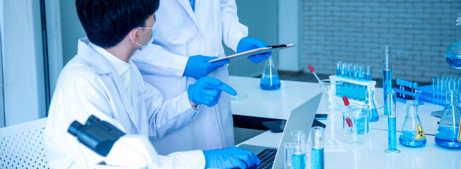 Banner Two asian scientist men team partner shake hands together. Men researcher holding chemistry...