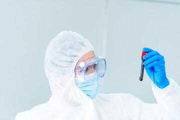 Scientist man holding sample blood test tube in science laboratory. Doctor clinic healthcare...