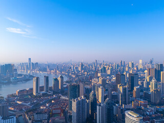 Fototapeta premium Aerial view of Shanghai skyline with winding river at sunrise.