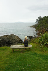 a woman walking around Waipu pancake rocks in Waipu, New Zealand.