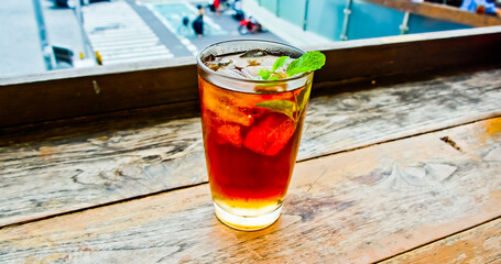 view of a glass of iced tea topped with mint leaves