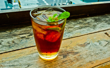 view of a glass of iced tea topped with mint leaves