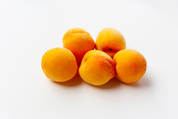 Fresh ripe apricots on a white background.