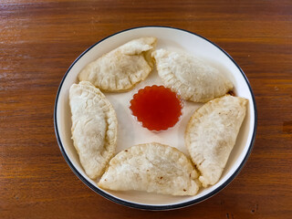 Close-up of crispy fried stuffed cireng served on a plate. Filled with seasoned chicken, this traditional Indonesian snack is savory and perfect for any time.