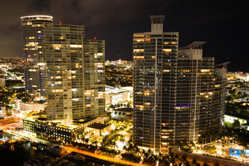 Aerial night view of Miami coastline. Twilight skyline above the Miami oceanfront. Miami Beach...