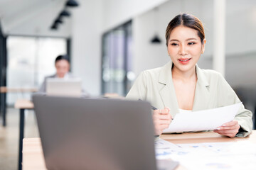 portrait of an attractive young businesswoman working on her laptop while sitting in the office.