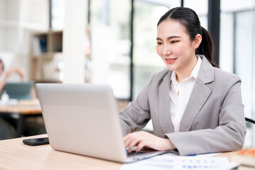 portrait of an attractive young businesswoman working on her laptop while sitting in the office.