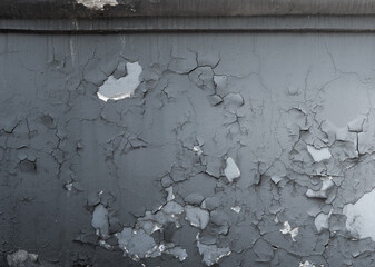 Close-Up of Cracked Paint on a Weathered Gray Wall