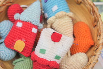 Colorful handmade keychains in a woven basket display