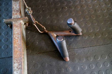 Rusty Gym Equipment Handle on Textured Floor