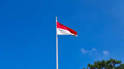 Yogyakarta, June 24, 2025 : The Indonesian flag, a vibrant red and white bicolor, proudly waves...