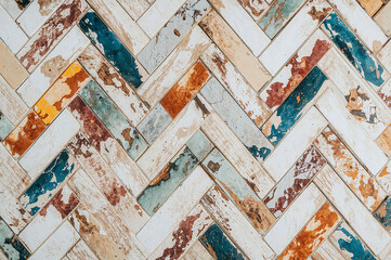 Vibrant herringbone tiles on white wood paneling