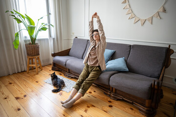 Lethargic female lying back with lazy stretch, unable to motivate herself despite having time and space. Apathy-driven pause, mental fatigue, idle existence, detached mood, stillness, unmoving routine