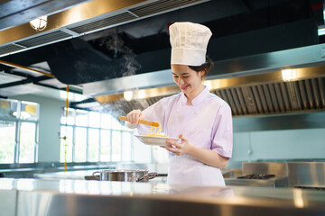 Caucasian girl enjoy with her cooking in a kitchen. Girl boiling a spaghetti.