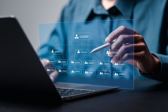 Businessman use laptop with business hierarchy structure for business process and workflow automation with flowchart. Relationships between members of the organization