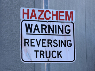 Hazchem - Warning Reversing Truck sign mounted on a metal pole