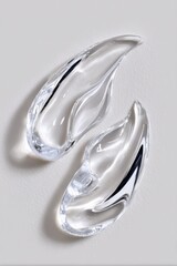 Elegant Transparent Glass Sculpture Art Piece with Smooth Curves and Reflective Surface for Modern Interior Decor