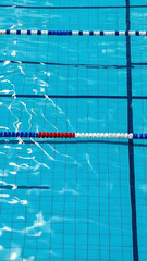 Obraz premium Top-Down Realistic View of Swimming Pool with Lane Dividers and Ripples