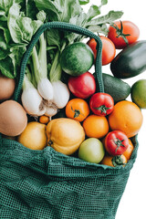 Fresh produce overflowing a green mesh bag
