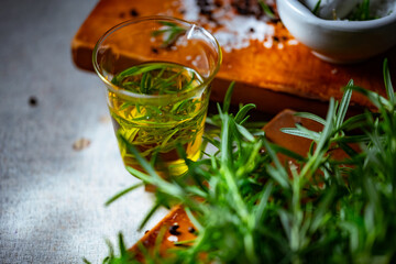 Rosemary, Salt, and Olive Oil.

Fresh rosemary, rock salt, and olive oil on a cutting board,...