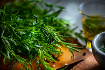 Rosemary, Salt, and Olive Oil.

Fresh rosemary, rock salt, and olive oil on a cutting board, perfect for culinary themes.
