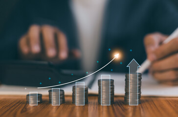 Businessman using calculator and financial planning with growing coin stack and digital arrow graph showing profit and business success. Concept of investment, saving, management and economic growth.