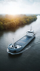 Naklejka premium Ecofriendly freight vessel cargo ship solar panel river sustainable transportation green energy sunrise nature waterway