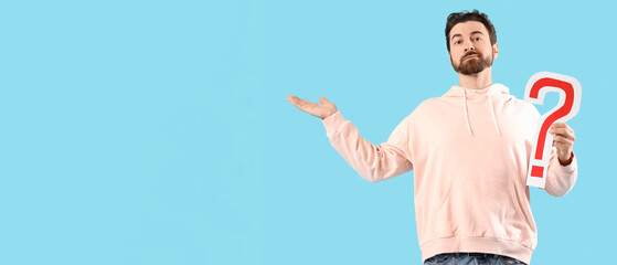 Bearded man with question mark on blue background