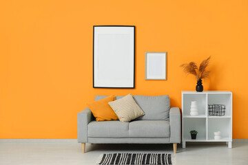 Comfortable sofa and shelving unit in interior of living room