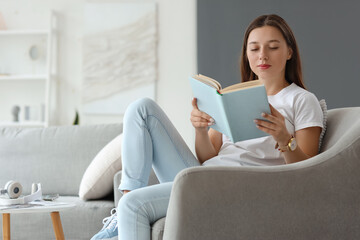 Young woman reading book on her day off at home