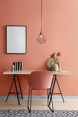 Stylish interior of room with workplace and blank poster hanging on color wall