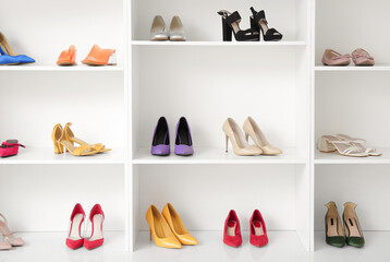 Shelves with different female shoes in boutique