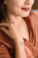 Beautiful young Asian woman with stylish bracelets, closeup