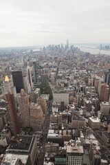 Depicting Manhattan skyline rising in flat design, showing grid streets with skyscrapers and taxis