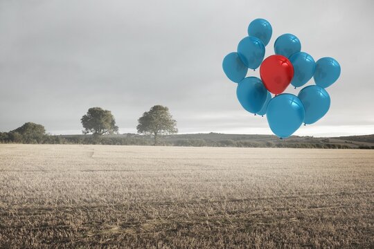 Fototapeta Helium balloon cluster is floating over stubble field with distant trees in flat design, cloudy sky
