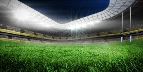Flat design covered stadium is showcasing floodlights lighting green pitch with rugby goal posts