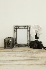 Photo frame, speaker and camera on table