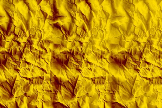 Close-up flat design illustration showing crumpled yellow paper filling frame with textured folds