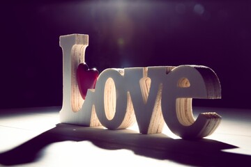 Digitally generated image of word love and red heart